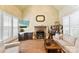 Cozy living room featuring a stone fireplace, a television, and natural light at 10007 Hillspring Dr, Huntersville, NC 28078