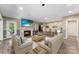 Open-concept living room with stone fireplace, bar seating, and luxury vinyl flooring at 10007 Hillspring Dr, Huntersville, NC 28078