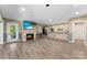 Spacious living room features luxury vinyl flooring and a stone-accented bar area at 10007 Hillspring Dr, Huntersville, NC 28078