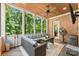 Cozy screened-in porch with comfortable seating and a view of the surrounding trees at 10007 Hillspring Dr, Huntersville, NC 28078