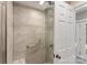 Walk-in shower featuring seamless glass door and a built-in bench at 10007 Hillspring Dr, Huntersville, NC 28078