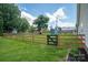 Expansive fenced backyard with lush green grass and a beautiful wooden fence at 104 Nottingham Dr, Maiden, NC 28650