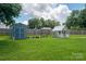 Large backyard featuring a shed and playhouse on a well-maintained lawn at 104 Nottingham Dr, Maiden, NC 28650