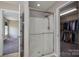 Bright bathroom featuring a glass-enclosed shower and entry to walk-in closet at 104 Nottingham Dr, Maiden, NC 28650