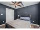 Bedroom featuring a ceiling fan, dark walls, and large double closet at 104 Nottingham Dr, Maiden, NC 28650