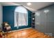 Cozy bedroom with an arch window, hardwood floors, and custom gray cabinets at 104 Nottingham Dr, Maiden, NC 28650