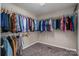Walk-in closet with ample hanging space, shelving, and carpeted floor at 104 Nottingham Dr, Maiden, NC 28650
