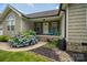 Inviting front porch with stone facade, blue chairs, and vibrant hydrangeas creating a warm entrance at 104 Nottingham Dr, Maiden, NC 28650
