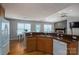 Kitchen featuring wood cabinets, a stainless steel sink, and views of the living room and dining area at 104 Nottingham Dr, Maiden, NC 28650