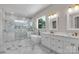 Bright bathroom features double sink vanity, marble floors and walls, soaking tub and glass shower at 106 Kelly Marie Ct, Kings Mountain, NC 28086