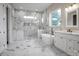 Luxurious bathroom featuring marble floors and walls, a soaking tub, and a glass-enclosed shower at 106 Kelly Marie Ct, Kings Mountain, NC 28086