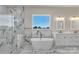 Bright bathroom features marble floors and walls, soaking tub, glass shower, double sink vanity and window at 106 Kelly Marie Ct, Kings Mountain, NC 28086