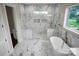 Elegant bathroom with a modern soaking tub, glass-enclosed shower, and marble floors and walls at 106 Kelly Marie Ct, Kings Mountain, NC 28086