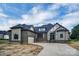 Beautiful single-Gathering home featuring stone and brick accents, a gray roof, and a three-car garage at 106 Kelly Marie Ct, Kings Mountain, NC 28086
