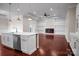 Open kitchen and living space with an island, modern fireplace, and white built-in shelving at 106 Kelly Marie Ct, Kings Mountain, NC 28086