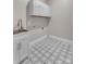 Bright laundry room with modern patterned tile floor and white cabinetry at 106 Kelly Marie Ct, Kings Mountain, NC 28086