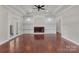 Open living room with fireplace, hardwood floors, and coffered ceilings at 106 Kelly Marie Ct, Kings Mountain, NC 28086