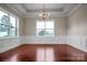Bright, modern living room with dark hardwood floors, stylish light fixture, and large windows at 106 Kelly Marie Ct, Kings Mountain, NC 28086