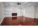 Elegant living room with coffered ceilings, a modern fireplace, built-in shelving, and gleaming hardwood floors at 106 Kelly Marie Ct, Kings Mountain, NC 28086