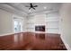 Elegant living room with coffered ceilings, a modern fireplace, built-in shelving, and gleaming hardwood floors at 106 Kelly Marie Ct, Kings Mountain, NC 28086