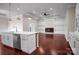 An open-concept kitchen and living room with a marble island, sleek countertops, and modern pendant lighting at 106 Kelly Marie Ct, Kings Mountain, NC 28086