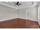 Spacious bedroom with tray ceiling, ceiling fan, hardwood floors and access to the main bathroom at 106 Kelly Marie Ct, Kings Mountain, NC 28086
