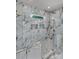 Detailed view of the glass shower featuring beautiful marble walls, tile details and gold hardware at 106 Kelly Marie Ct, Kings Mountain, NC 28086