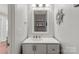 Charming bathroom features a white vanity, nautical decor, and decorative mirror at 11023 Kinston Ridge Pl, Charlotte, NC 28273