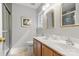 Bathroom with double sink vanity, framed mirrors, and glass shower at 11023 Kinston Ridge Pl, Charlotte, NC 28273