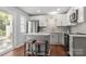 Modern kitchen with stainless steel appliances, granite countertops, and a cozy breakfast bar at 11023 Kinston Ridge Pl, Charlotte, NC 28273