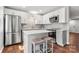 Stylish kitchen featuring stainless steel appliances, white cabinets, granite countertops, and a central island at 11023 Kinston Ridge Pl, Charlotte, NC 28273
