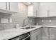 Close-up of kitchen with granite countertops, tile backsplash, and stainless steel sink at 11023 Kinston Ridge Pl, Charlotte, NC 28273