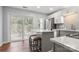 Modern kitchen featuring stainless steel appliances, island, and sliding glass doors at 11023 Kinston Ridge Pl, Charlotte, NC 28273