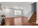 Bright living room with hardwood floors, ample natural light, and staircase to the second floor at 11023 Kinston Ridge Pl, Charlotte, NC 28273