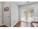 Bright room with wood floors featuring sliding glass doors to outdoor patio at 11023 Kinston Ridge Pl, Charlotte, NC 28273