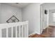 Stairway features white banister with modern pendant lighting at 11023 Kinston Ridge Pl, Charlotte, NC 28273