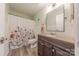 Bathroom with a floral shower curtain, a wood vanity, and plenty of light at 11834 Carmel Lakes Dr, Charlotte, NC 28226