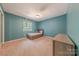 Bedroom painted in an accent color and featuring a bed, a dresser, and a window at 11834 Carmel Lakes Dr, Charlotte, NC 28226