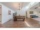 Open floor plan featuring a dining area with a wooden table and a seating area at 11834 Carmel Lakes Dr, Charlotte, NC 28226