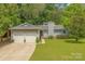 Charming single-story home with a well-maintained lawn and an attached two-car garage at 11834 Carmel Lakes Dr, Charlotte, NC 28226