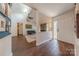 Bright, open-concept living room featuring a stone fireplace and hardwood floors at 11834 Carmel Lakes Dr, Charlotte, NC 28226