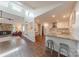 Open living space with stone fireplace, kitchen with breakfast bar, and hardwood floors at 11834 Carmel Lakes Dr, Charlotte, NC 28226