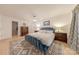 Cozy main bedroom with a large plush bed, wooden floors, and bright natural light at 11834 Carmel Lakes Dr, Charlotte, NC 28226