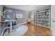 Home office with a bookshelf full of books, a desk, and natural light from the window at 11834 Carmel Lakes Dr, Charlotte, NC 28226
