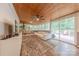 Bright sunroom with a ceiling fan, wood ceilings, and view of the back deck at 11834 Carmel Lakes Dr, Charlotte, NC 28226