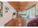 Sunroom featuring wood ceilings and floors, a couch, and glass doors to the outside at 11834 Carmel Lakes Dr, Charlotte, NC 28226