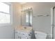 Well-lit bathroom with a white vanity, large mirror, and functional fixtures at 120 Tower Dr, Statesville, NC 28677