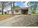 View of the home showing a covered parking area and a driveway leading to the front entrance at 120 Tower Dr, Statesville, NC 28677