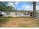 Charming single-story home featuring a covered front porch and neutral siding with decorative shutters at 120 Tower Dr, Statesville, NC 28677