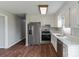 Modern kitchen with white countertops, stainless steel appliances, and ample cabinet space at 120 Tower Dr, Statesville, NC 28677